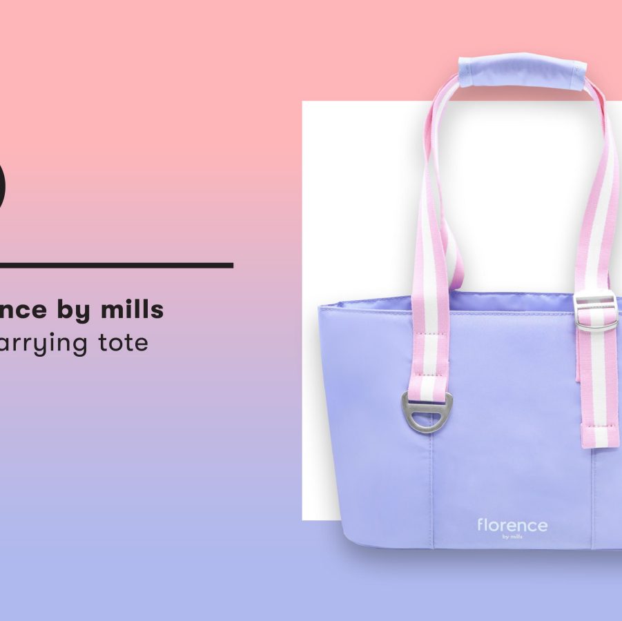 A purple pet carrier tote with pink and white straps and a cut-out for your pet to stick out their head. 
